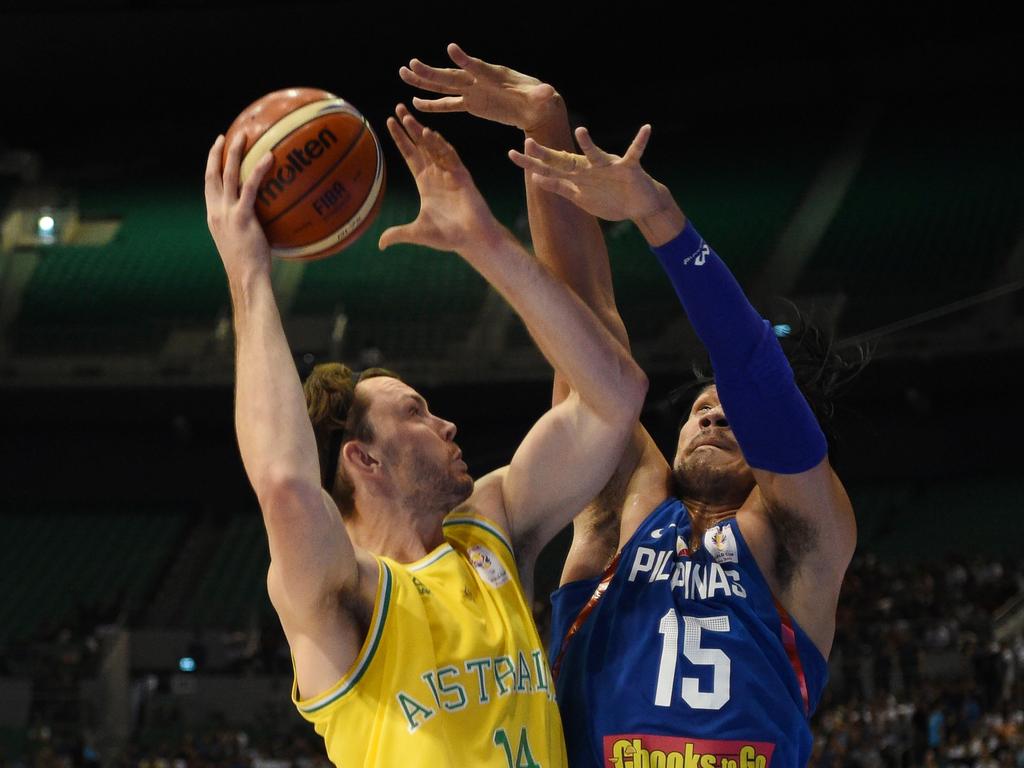 June Fajardo (R) of the Philippines blocks a shot of Australia's Angus Brandt during their FIBA World Cup Asian qualifier game at the Philippine arena in Bocaue town, Bulacan province, north of Manila on July 2, 2018. Australia won by default 89-53. Australia won by default 89-53. / AFP PHOTO / TED ALJIBE