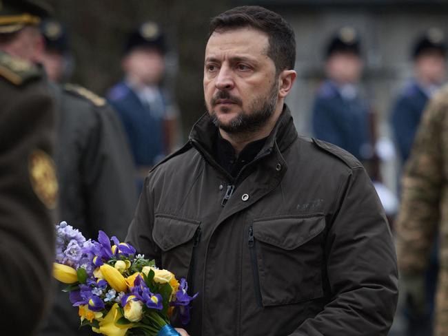 In this handout photograph taken and released by the Ukrainian Presidential Press Service on January 29, 2025, Ukraine's President Volodymyr Zelensky arrives to lay flowers during a ceremony in Kyiv to commemorate the 107th anniversary of the Battle of Kruty against Bolshevik Red Army. (Photo by Handout / Ukrainian Presidential press service / AFP) / RESTRICTED TO EDITORIAL USE - MANDATORY CREDIT "AFP PHOTO / UKRAINIAN PRESIDENTIAL PRESS SERVICE" - NO MARKETING NO ADVERTISING CAMPAIGNS - DISTRIBUTED AS A SERVICE TO CLIENTS