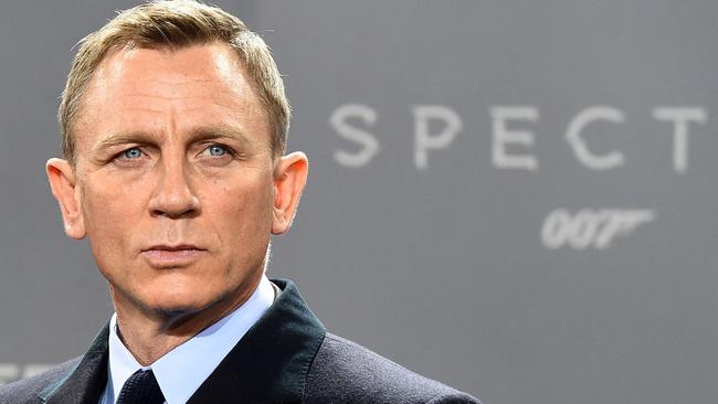 (FILES) In this file photo taken on October 28, 2015 British actor Daniel Craig poses for photographers at a photocall for the new James Bond film 'Spectre' in Berlin. - New James Bond footage from historic Hollywood studio MGM shook and stirred the movie theater industry's CinemaCon summit in Las Vegas August 24, 2021, as executives struck a defiant note about the future of the big screen. (Photo by TOBIAS SCHWARZ / AFP)