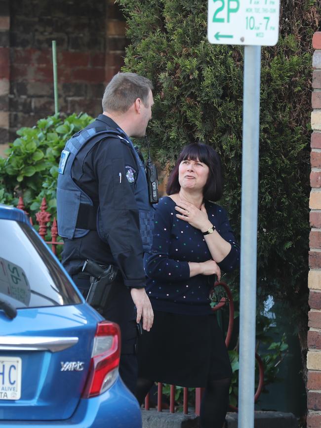 A police officer with an unknown woman at the scene. Picture: Alex Coppel