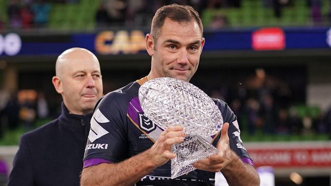 Cameron Smith with his custom-designed crystal football the NRL announced it was giving the Storm skipper, as Todd Greenberg watches on. Picture: Scott Barbour/Getty Images