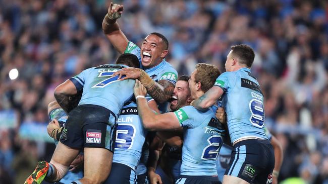 Blues players celebrate victory in State of Origin II at ANZ Stadium. Photo: Brett Costello