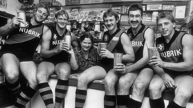 Essendon stars Tim Watson, Paul van der Haar, Garry Foulds Roger Merrett and Mark Thompson visit the local milk bar (run by supporter Irene Clancy) for a treat.