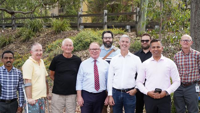 Hugh McDermott, John Graham and Sameer Pandey with members of the Toongabbie community.