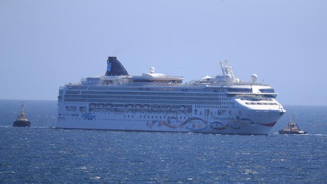 Norwegian Star getting towed though the heads by two tugboats. Picture: Alex Coppel