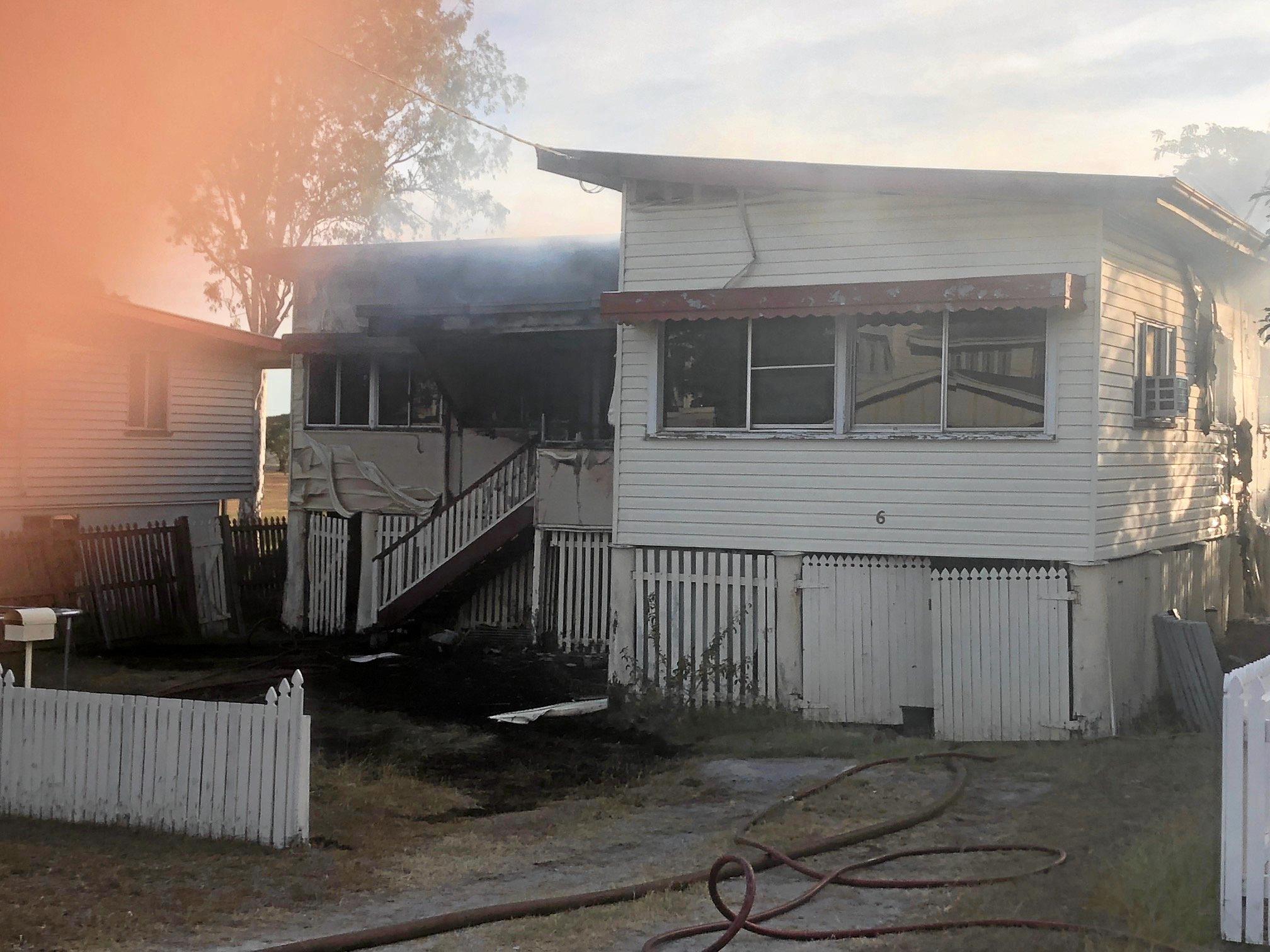 Firefighters at the scene of a house fire on Naughton St, Wandal, this afternoon. Reports indicate the top part of the house is gutted but firefighters are walking in through the front door.