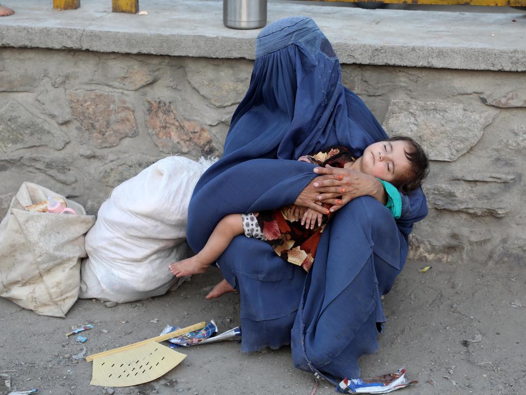 A woman holds her sleeping child. Picture: Sayed Khodaiberdi Sadat/Anadolu Agency via Getty Images