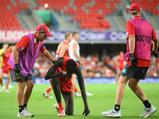 GOLD COAST, AUSTRALIA - FEBRUARY 28: Mac Andrew of the Suns receives attention on the field during the 2025 AAMI AFL Community Series match between Gold Coast Suns and Sydney Swans at People First Stadium on February 28, 2025 in Gold Coast, Australia. (Photo by Matt Roberts/AFL Photos/via Getty Images)