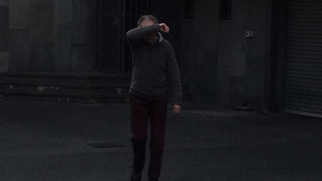 Sonny Day shields his face as he walks free from the Tasmanian Supreme Court in Hobart . (AAP Image/Andrew Drummond)