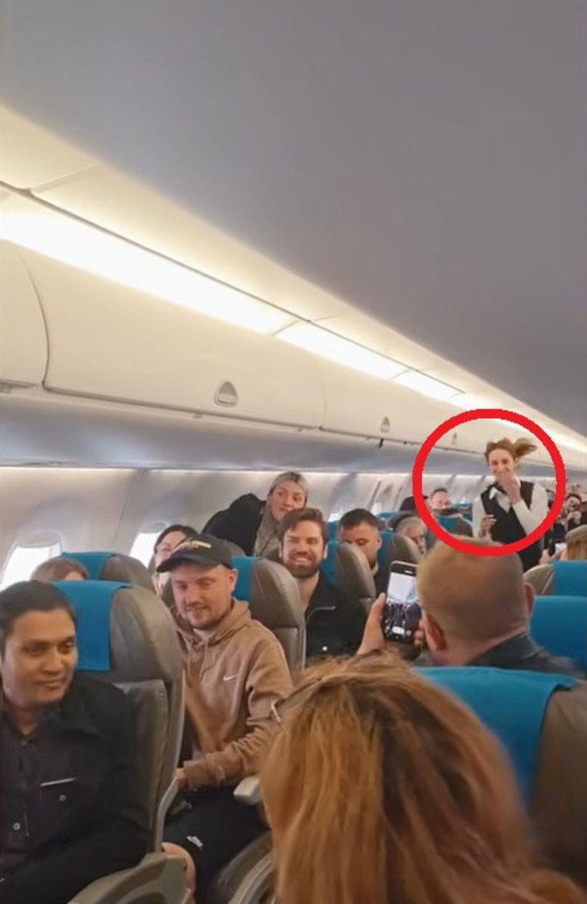 She could be seen running down the aisle after he got down on one knee and popped the question. Picture: Facebook/LOT Polish Airlines