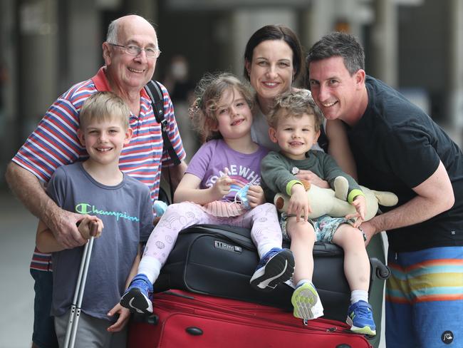 Darren and Marie Rowland with their kids Noah, Eliana, Lachlan and Grandad Skipper at the airport. Pic: Annette Dew