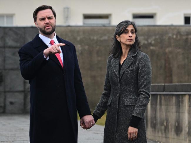 US Vice President JD Vance (L) stands with his wife Usha Vance as they take part in a tour of the Dachau Concentration Camp memorial site in Dachau, southern Germany, on February 13, 2025. The US Vice President will participate in the Munich Security Conference (MSC). (Photo by Tobias SCHWARZ / AFP)