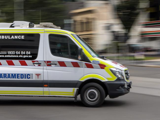 MELBOURNE, AUSTRALIA - NewsWire Photos FEBRUARY 13, 2022: An ambulance speeds away from the Royal Melbourne Hospital. Ambulance, Generic.Picture: NCA NewsWire / David Geraghty