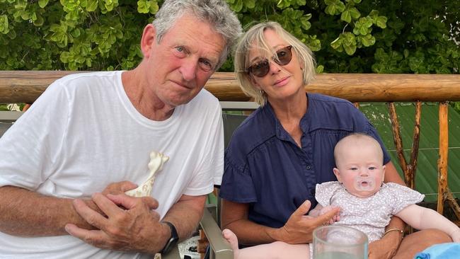 Tom Kirk KC and his wife, Wendy, with one of their many grandchildren.