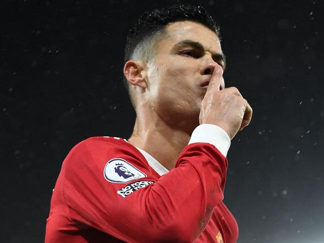 Manchester United's Portuguese striker Cristiano Ronaldo celebrates after scoring the opening goal from the penalty spot during the English Premier League football match between Norwich City and Manchester United at Carrow Road Stadium in Norwich, eastern England, on December 11, 2021. (Photo by Daniel LEAL / AFP) / RESTRICTED TO EDITORIAL USE. No use with unauthorized audio, video, data, fixture lists, club/league logos or 'live' services. Online in-match use limited to 120 images. An additional 40 images may be used in extra time. No video emulation. Social media in-match use limited to 120 images. An additional 40 images may be used in extra time. No use in betting publications, games or single club/league/player publications. /