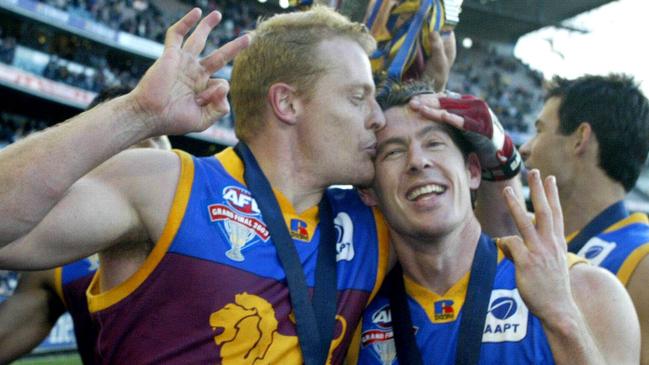 Craig McRae and Michael Voss celebrate the Lions’ premiership three-peat. Pic Kelly Barnes