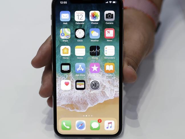 The new iPhone X is displayed in the showroom after the new product announcement at the Steve Jobs Theater on the new Apple campus on Tuesday, Sept. 12, 2017, in Cupertino, Calif. (AP Photo/Marcio Jose Sanchez)