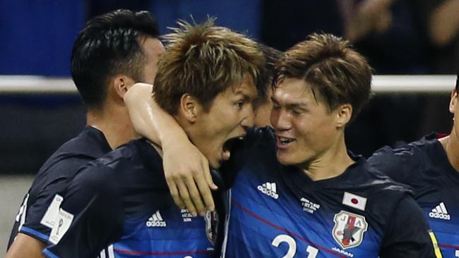 Japan's Genki Haraguchi (L) celebrates his goal against Iraq.