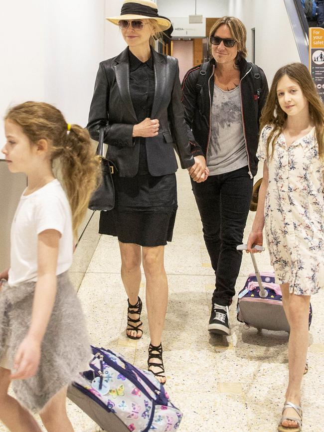 Balancing work and family, Nicole and Keith fly into Sydney with their children earlier this year. Picture Jenny Evans