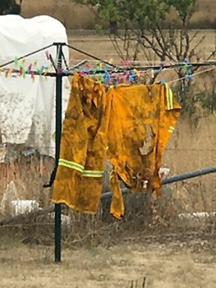 Burnt overalls hanging on a clothes line in Taralga. Pic: Warren Brown