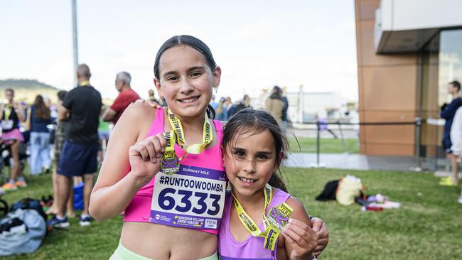 Siblings Ava (left) and Sofia Gard show their Runway Mile medals after running in the Toowoomba Marathon events at Wellcamp Airport, Saturday, May 3, 2025. Picture: Kevin Farmer