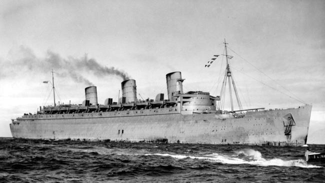 Former cruise ship the Queen Mary enters the heads of Sydney Harbour decked out in her camouflage dull grey paint, in 1940.