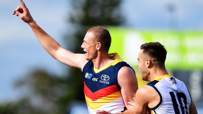 Sam Jacobs of the Adelaide Crows celebrates a goal with Myles Poholke at Glenelg yesterday. Picture: Mark Brake/Getty Images