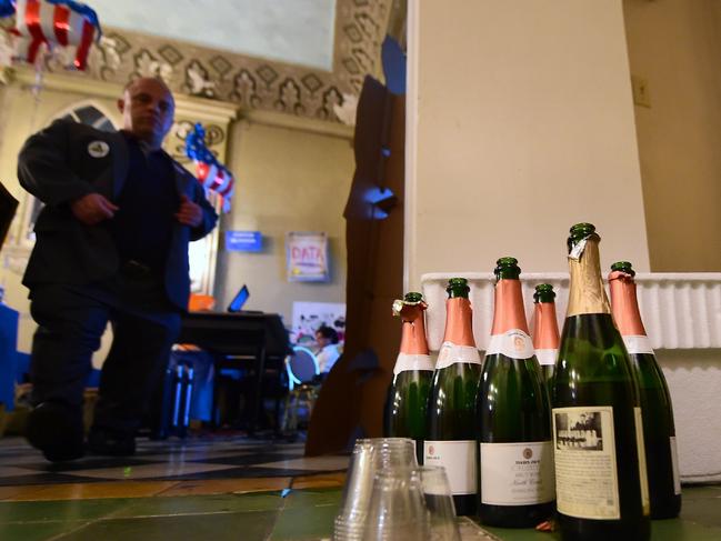 Opened bottles of champagne stand on the floor in a corner of Democratic presidential candidate Hillary Clinton's party headquarters during an election watch party in East Los Angeles on November 8, 2016. / AFP PHOTO / FREDERIC J. BROWN