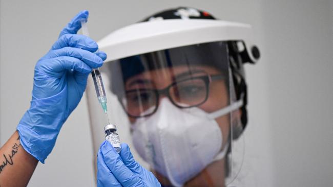 A health worker prepares a dose of the Pfizer-BioNTech vaccine. Picture: AFP