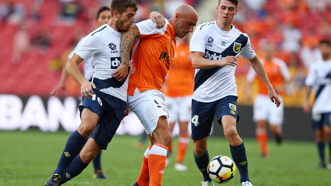 Central Coast’s Liam Rose and Massimo Maccarone of the Roar at Suncorp Stadium yesterday
