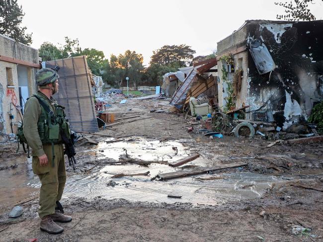 Israeli troops search the scene of a rocket attack in the Israeli kibbutz of Kfar Aza on the border with the Gaza Strip. Picture: AFP