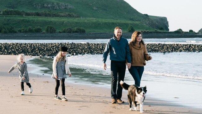 Owners of the Ship Inn Alastair and Kerry Houston, walking their border collie Floss, on Godfrey's Beach, at Stanley, with their daughters Lucy and Bonnie. Picture: Supplied.