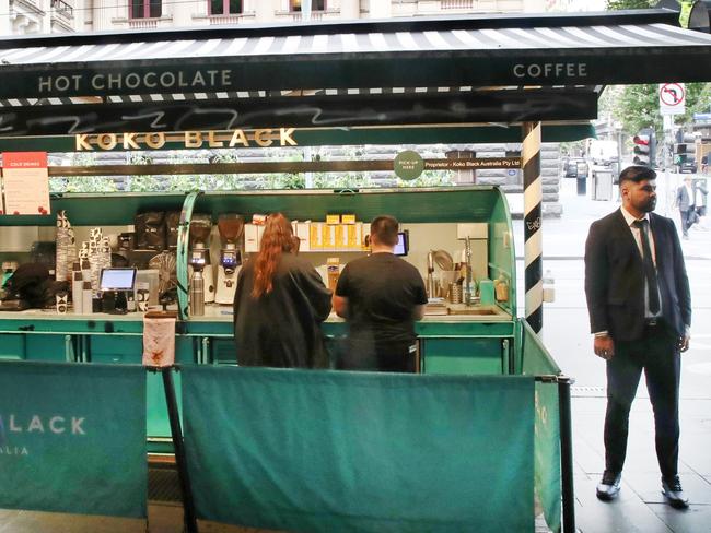 Swanston St images in Melbourne cbd. Koko Black coffee stand has a security guard. Wednesday, January 15. 2025.