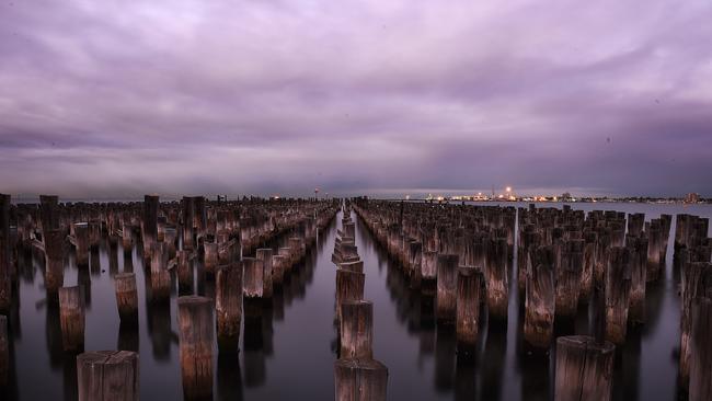 Clouds gather over Princes Pier, Port Melbourne, in the early light. Picture: Jake Nowakowski