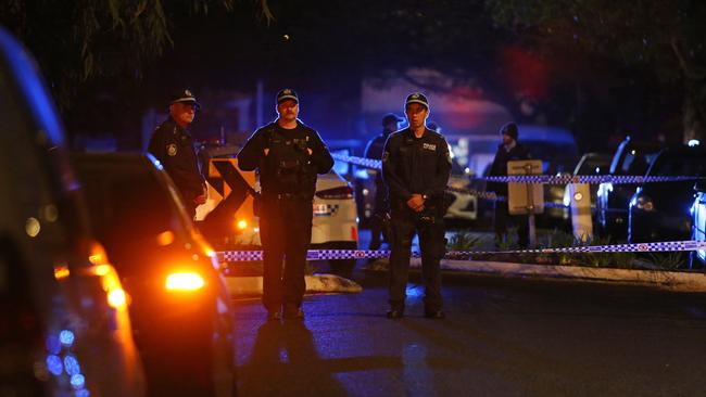 Police at the scene of the alleged shooting on Garrong Rd in Lakemba. Picture: Richard Dobson