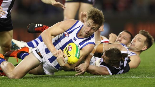 Trent Dumont gets a handball away falling to the ground.