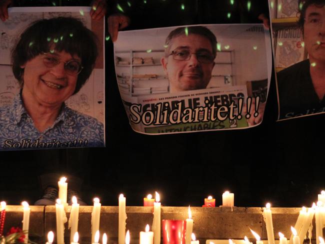 Albanian journalists hold pictures of French satirical weekly Charlie Hebdo's cartoonists (From L) Jean Cabut aka Cabu, Charb and Tignous during a gathering in solidarity with the victims of the terror attack at Charlie Hebdo in Paris earlier today, in Tirana on January 7, 2015. France's Muslim leadership sharply condemned the shooting at the Paris satirical weekly that left at least 12 people dead as a "barbaric" attack and an assault on press freedom and democracy. AFP PHOTO / GENT SHKULLAKU