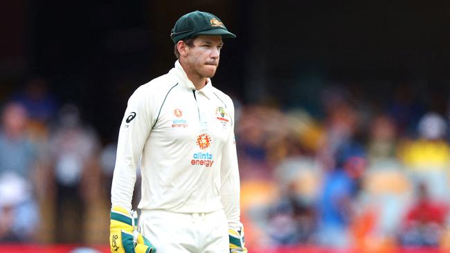 (FILES) This file photo taken on January 19, 2021 shows Australia's captain Tim Paine looking on between the overs on day five of the fourth cricket Test match between Australia and India at The Gabba in Brisbane. - Tim Paine announced his shock resignation as Australian Test cricket captain on November 19, 2021 over what he described as an inappropriate "private text exchange" with a then-colleague. (Photo by PATRICK HAMILTON / AFP) / — IMAGE RESTRICTED TO EDITORIAL USE - STRICTLY NO COMMERCIAL USE —