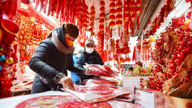 People buying decorations ahead of New Year’s day at a market in Qingdao, in China’s eastern Shandong province. Picture: AFP