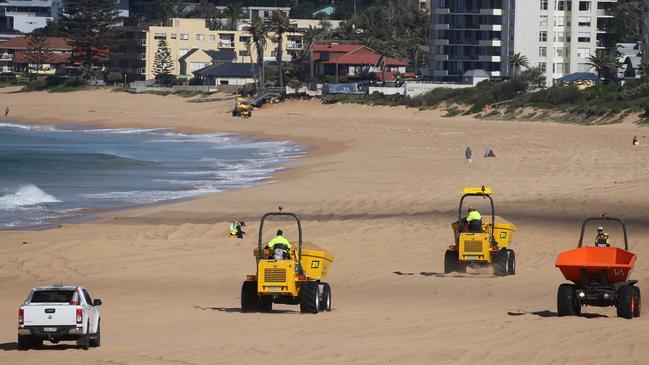 Council contractors moved tonnes of sand from the mouth of Narrabeen Lagoon south along the beach to Narrabeen and Collaroy to build up erosion prone areas. Picture: John Grainger