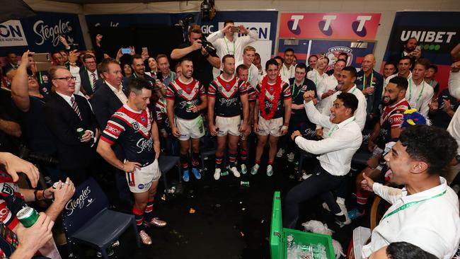 Players perform a dance for Cooper Cronk in the changing room after the Roosters win.