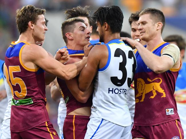 Ryan Lester (left), Dayne Zorko (middle) and Dayne Beams of the Lions takes on Aaron Hall of the Suns during the round 21 AFL match between the Brisbane Lions and the Gold Coast Suns played at the Gabba in Brisbane, Saturday, August 12, 2017. (AAP Image/Darren England) NO ARCHIVING, EDITORIAL USE ONLY