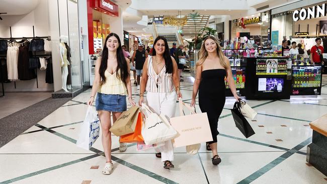 Last minute Christmas shopping is in full swing at shopping centres across Cairns, with car parks full and efptos machines in overdrive. Maya Charafeddine, Jade Sundman and Ashli O'Neill buy some last minute gifts for their family at Cairns Central Shopping Centre. Picture: Brendan Radke