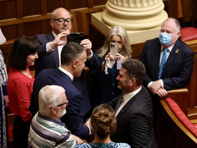 Premier Peter Malinauskas shakes hands with Minister for Aboriginal Affairs Kyam Maher in the Upper House of Parliament after a bill to legislate Australia’s first Voice to Parliament for First Nations People has been introduced in South Australia. Susan Close is in red. Picture: State Government