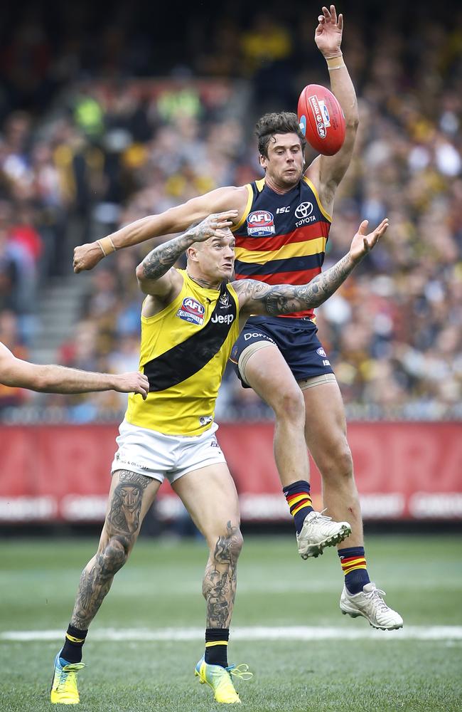 Richmond’s Dustin Martin goes for the ball against Adelaide’s Kyle Hartigan.