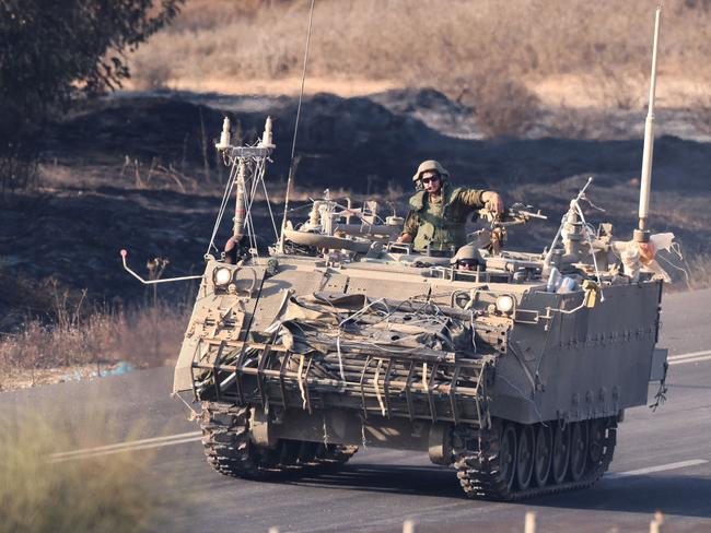 An Israeli vehicle moves with a military convoy along the border between Israel and the Gaza Strip. Picture: AFP