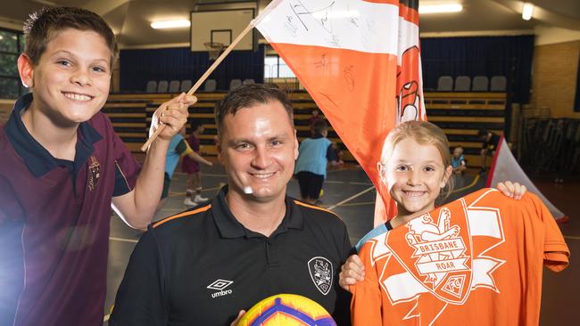 ROAR PRIDE: Toowoomba Anglican School students Hayden Johnston and Olivia McNicol talk football with Brisbane Roar Academy general manager Warren Moon. Picture: Kevin Farmer