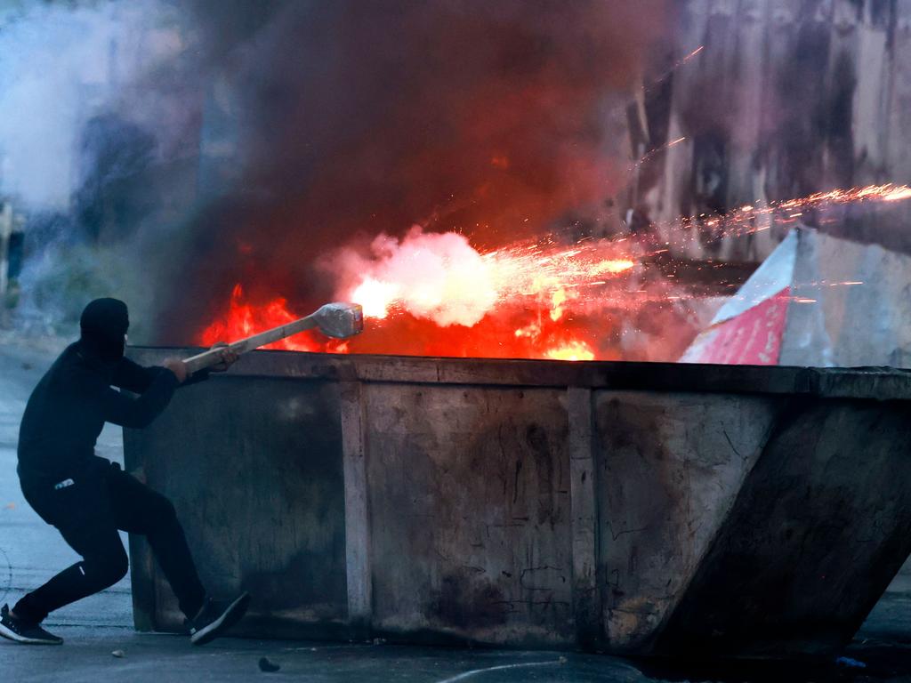 A Palestinian protester aims flares at Israeli troops amid clashes in Ramallah in the occupied West Bank. Picture: AFP