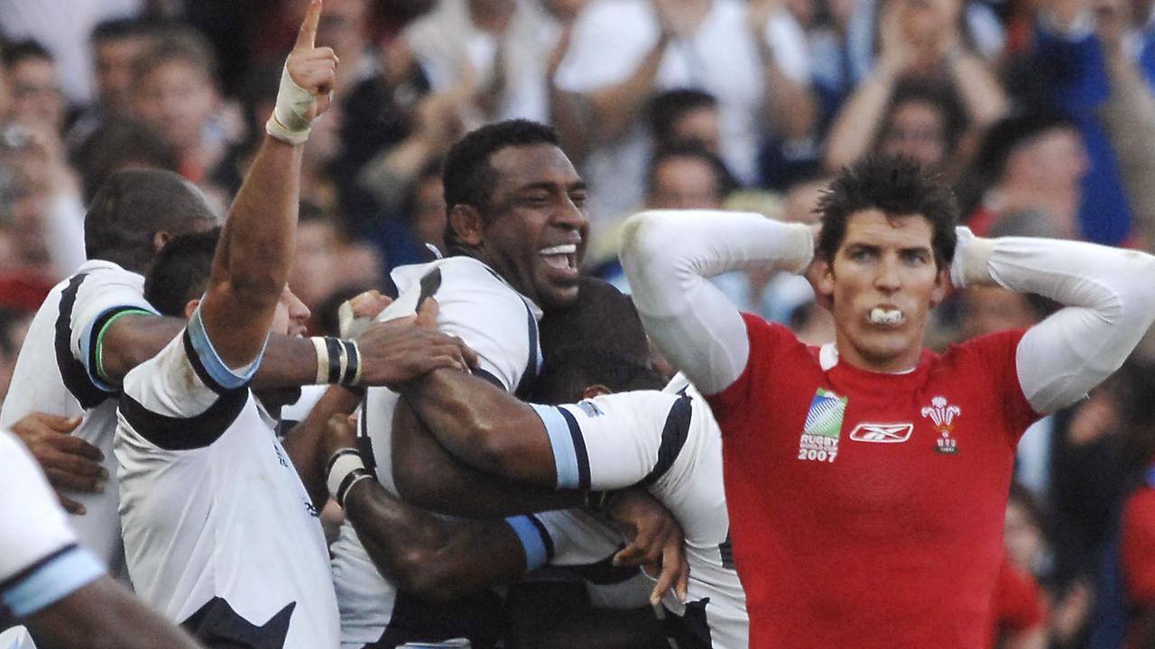 Wales centre James Hook reacts as Fiji players celebrate after their victory in Nantes.