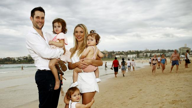 The Dovey Family, Michael and Lauren with their children Somerset, 3, and twins Willow and Violet, 1, on Bondi Beach. They are selling their Frederick St property. Picture: John Appleyard